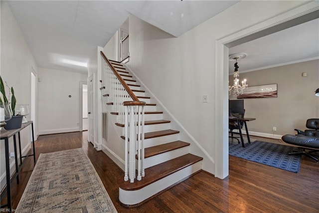 stairs with hardwood / wood-style floors, ornamental molding, and a chandelier