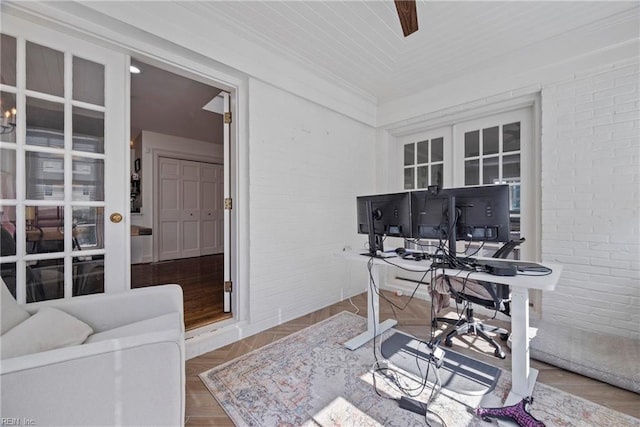 office with parquet flooring, wooden ceiling, and brick wall