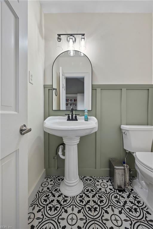 bathroom with tile patterned flooring and toilet