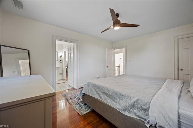 bedroom with wood-type flooring, ensuite bathroom, and ceiling fan