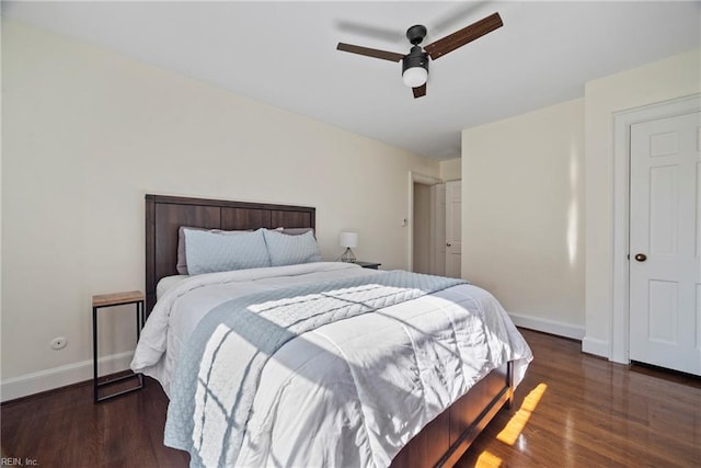 bedroom with dark hardwood / wood-style floors and ceiling fan