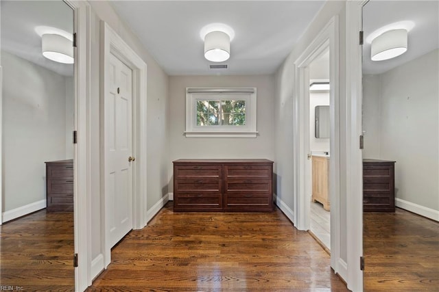 corridor featuring dark wood-type flooring