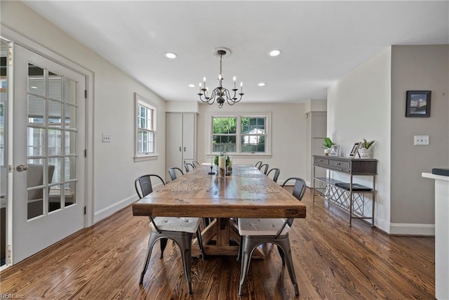 dining space featuring dark hardwood / wood-style flooring and a notable chandelier