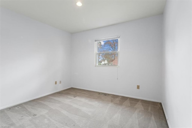 spare room with light colored carpet