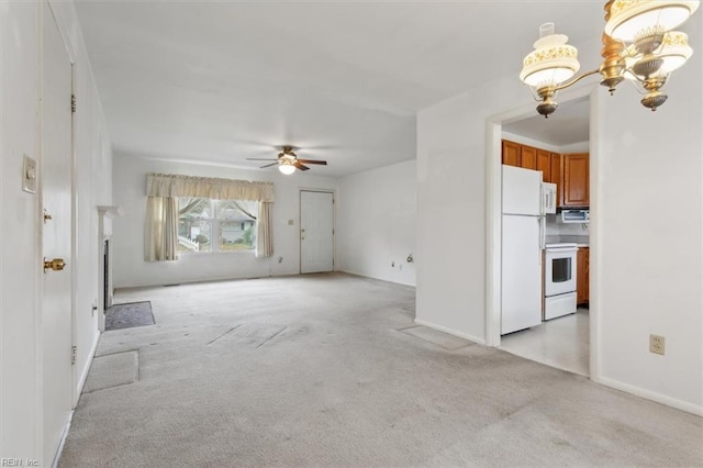 unfurnished living room with ceiling fan with notable chandelier and light colored carpet