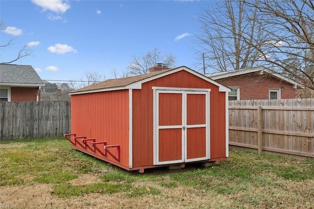 view of outbuilding with a yard