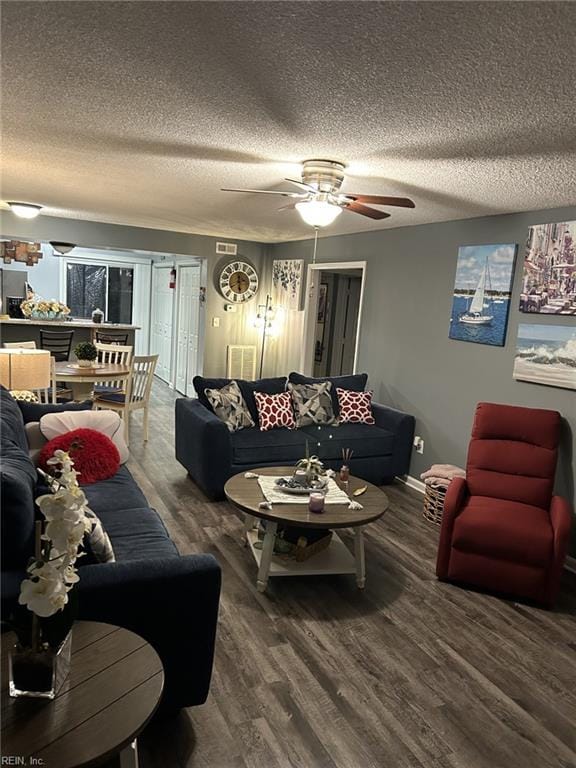 living room featuring ceiling fan, a textured ceiling, and hardwood / wood-style flooring