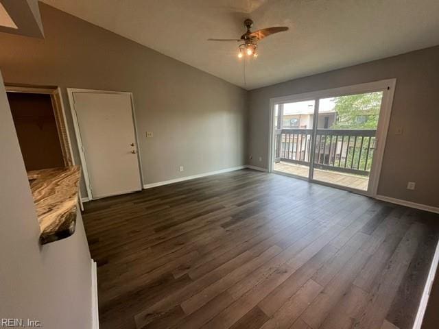 unfurnished room featuring ceiling fan, dark hardwood / wood-style flooring, and lofted ceiling