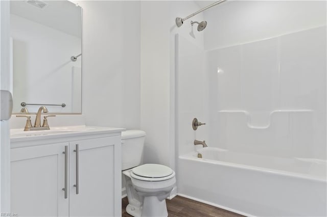 full bathroom featuring vanity, hardwood / wood-style flooring, toilet, and tub / shower combination