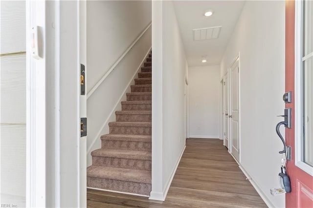 stairway featuring wood-type flooring