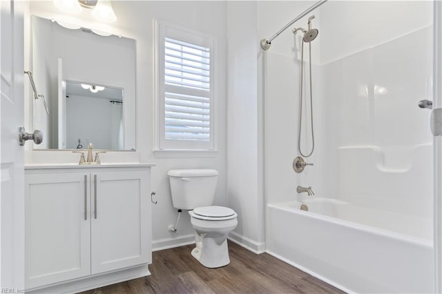 full bathroom with shower / tub combination, vanity, wood-type flooring, and toilet