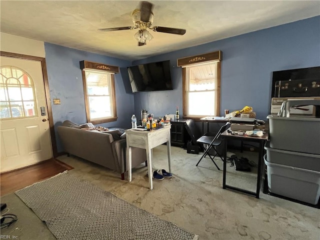 carpeted living room with plenty of natural light and ceiling fan