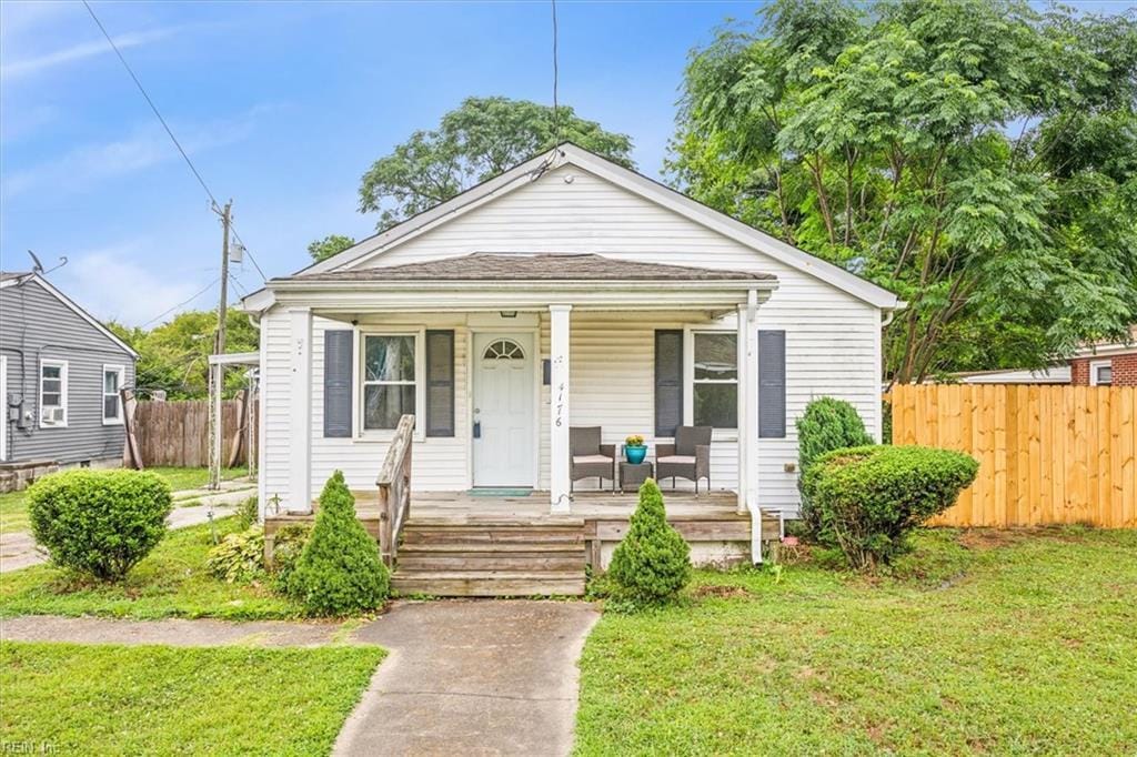 bungalow-style house featuring a porch and a front yard