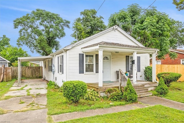 bungalow-style house featuring a porch and a carport