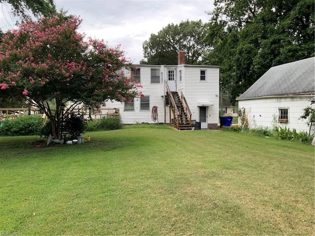 back of property with a lawn