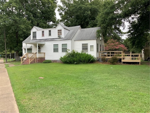 rear view of house with a wooden deck and a lawn