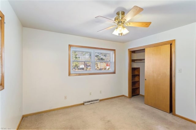 unfurnished bedroom featuring light carpet, a closet, a baseboard radiator, and ceiling fan