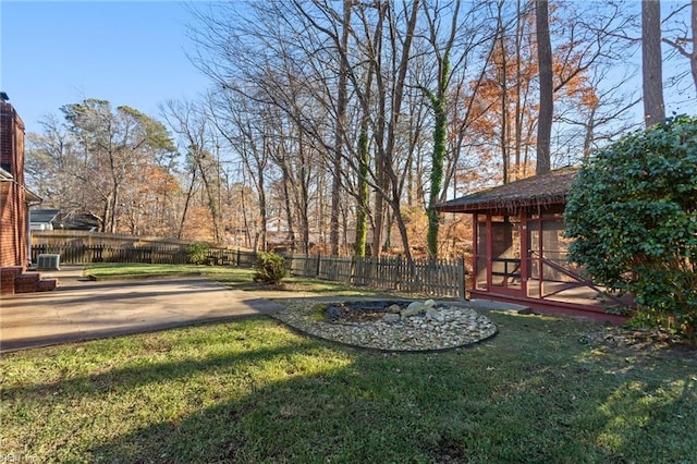 view of yard featuring a sunroom and a patio