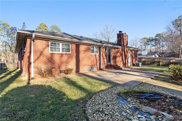 rear view of house featuring a lawn and a patio area