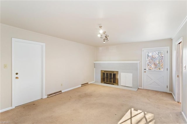 unfurnished living room featuring a baseboard heating unit, light colored carpet, crown molding, and a chandelier