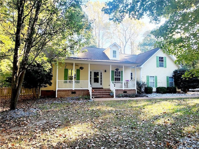 cape cod-style house featuring covered porch