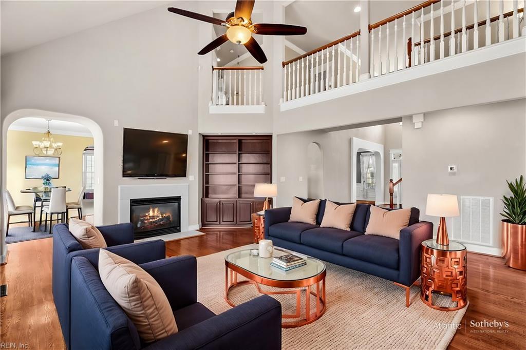 living room featuring wood-type flooring, high vaulted ceiling, and ceiling fan