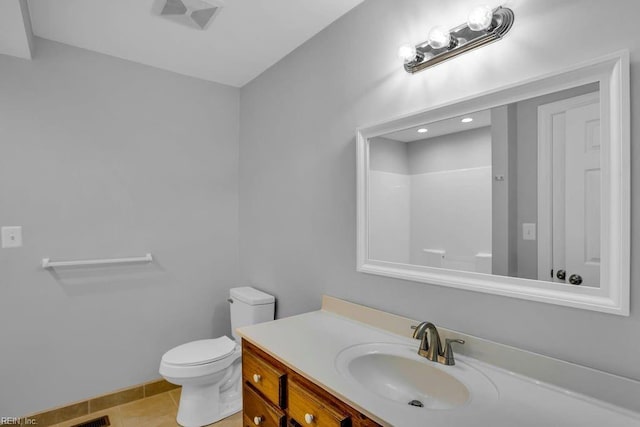 bathroom with tile patterned floors, walk in shower, vanity, and toilet