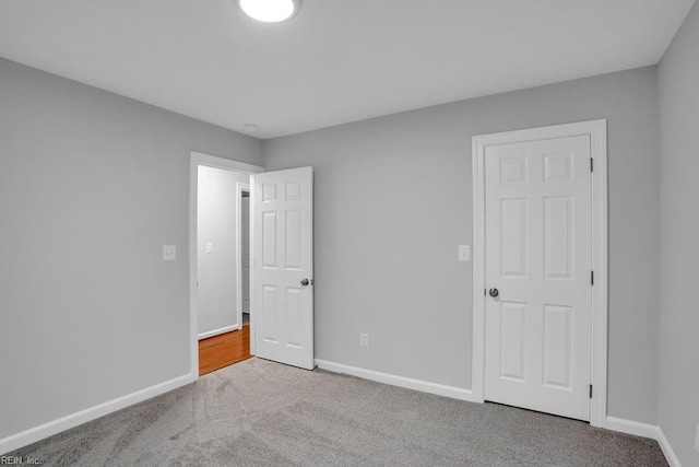 unfurnished bedroom with light colored carpet