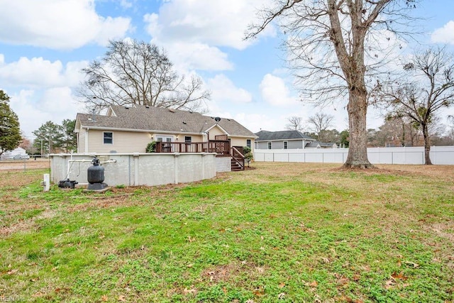 view of yard with a swimming pool side deck