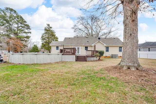 back of property featuring a swimming pool side deck, a yard, and central AC