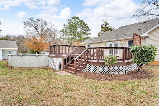 back of property with a swimming pool side deck and a yard