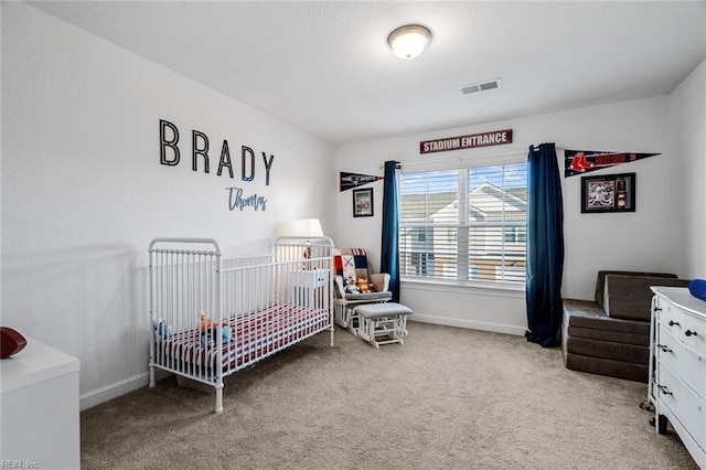 bedroom featuring carpet floors and a nursery area