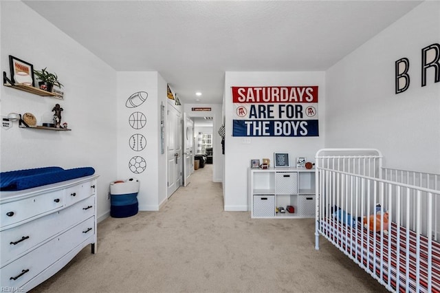 bedroom with a nursery area and light colored carpet