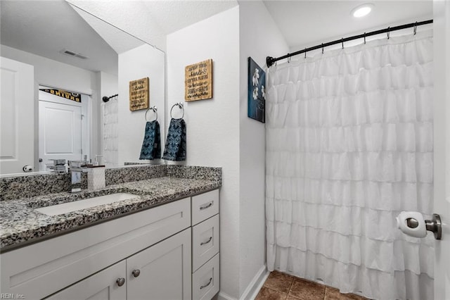 bathroom with tile patterned floors, a shower with curtain, and vanity