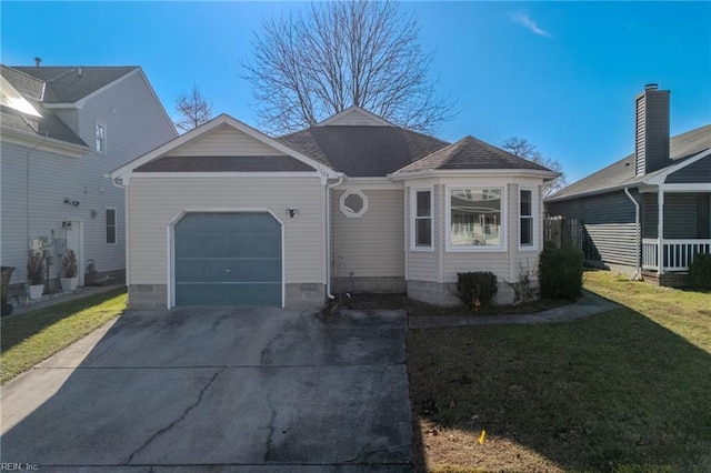 view of front of home with a front yard and a garage