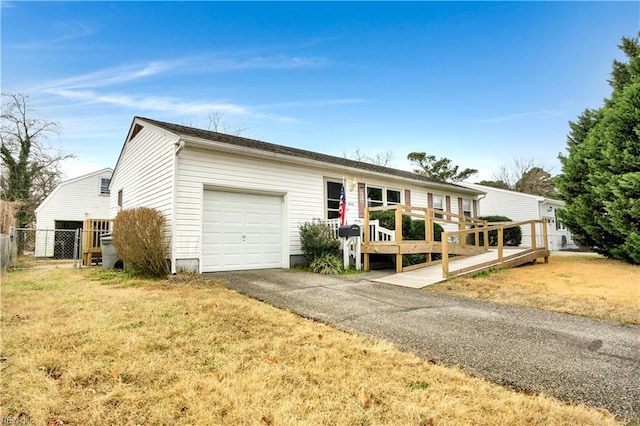 single story home with a garage, a wooden deck, and a front lawn