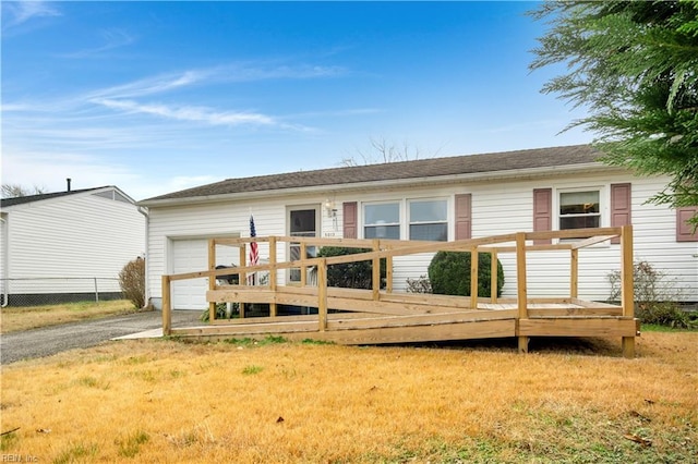 rear view of house with a lawn and a deck