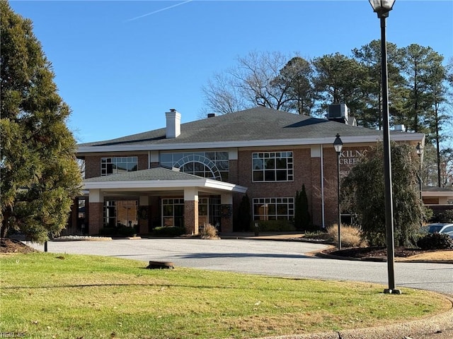 rear view of property with a yard