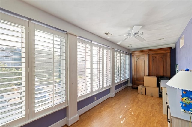 interior space with ceiling fan, plenty of natural light, and light hardwood / wood-style flooring