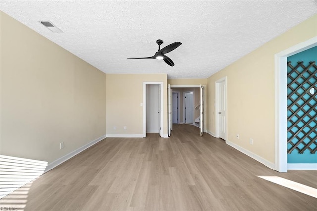 unfurnished bedroom with ceiling fan, a textured ceiling, and light hardwood / wood-style flooring