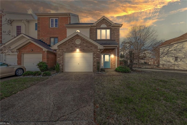 view of front of property featuring a yard and a garage