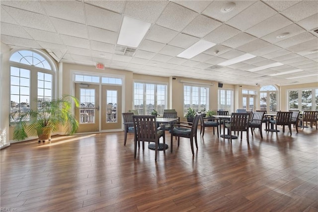 dining room featuring a drop ceiling and dark hardwood / wood-style flooring