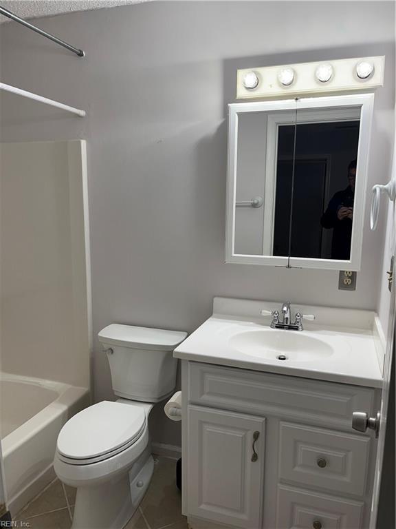 full bathroom with tile patterned flooring, shower / bathing tub combination, vanity, and toilet