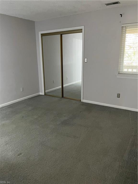 unfurnished bedroom featuring carpet floors and a closet