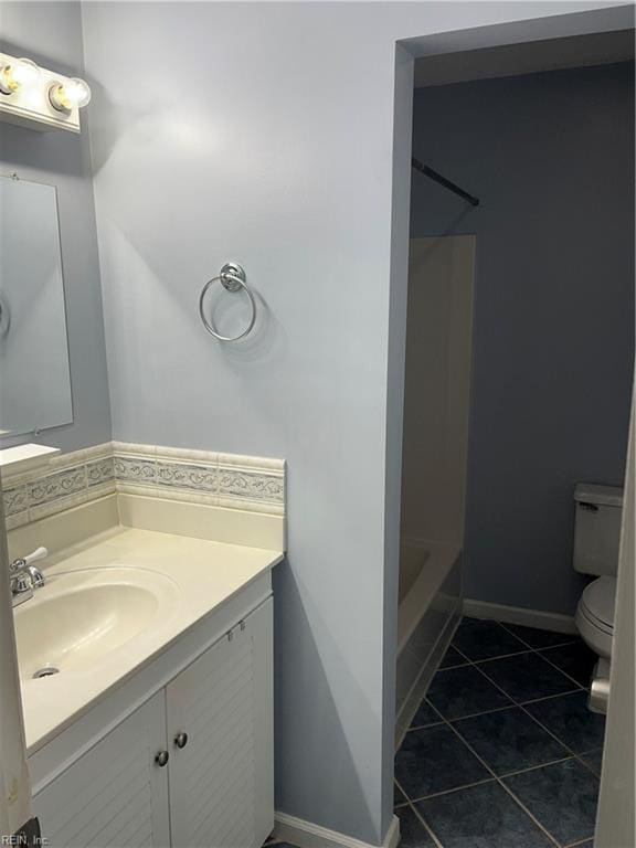 full bathroom with tile patterned flooring, vanity, shower / bathtub combination, and toilet