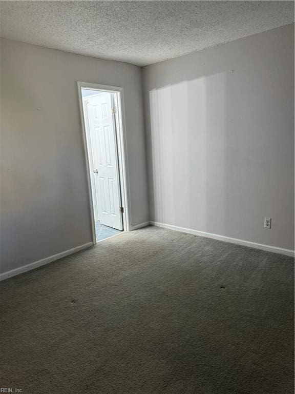 carpeted spare room featuring a textured ceiling