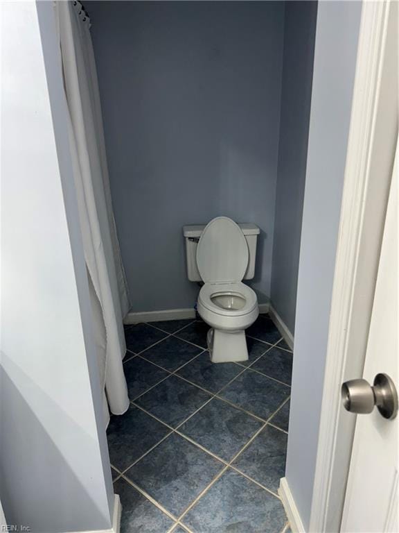 bathroom with tile patterned flooring and toilet