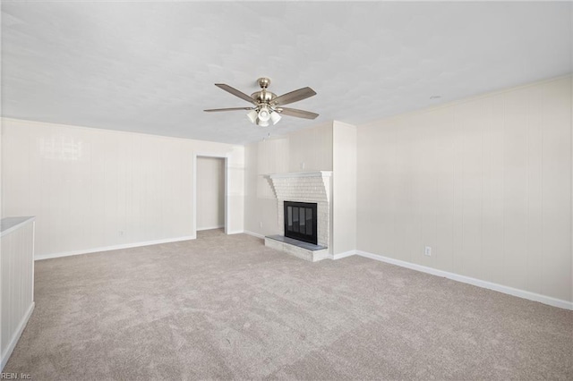 unfurnished living room featuring a fireplace, light carpet, and ceiling fan