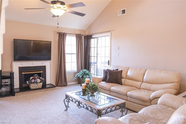 living room with ceiling fan, carpet floors, and high vaulted ceiling