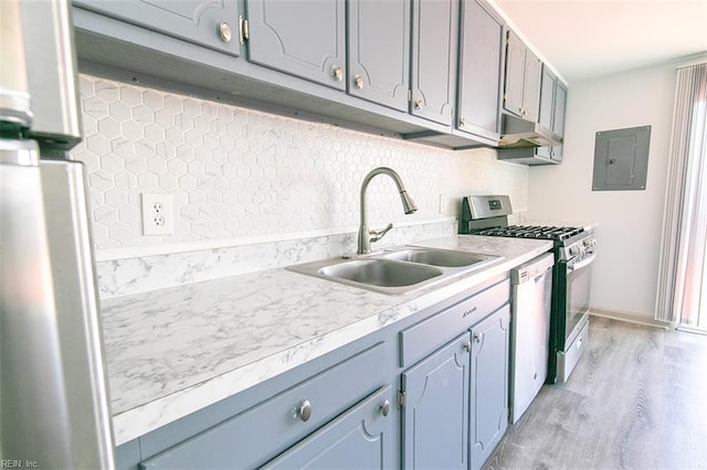 kitchen with dishwasher, electric panel, sink, light hardwood / wood-style flooring, and stainless steel gas stove